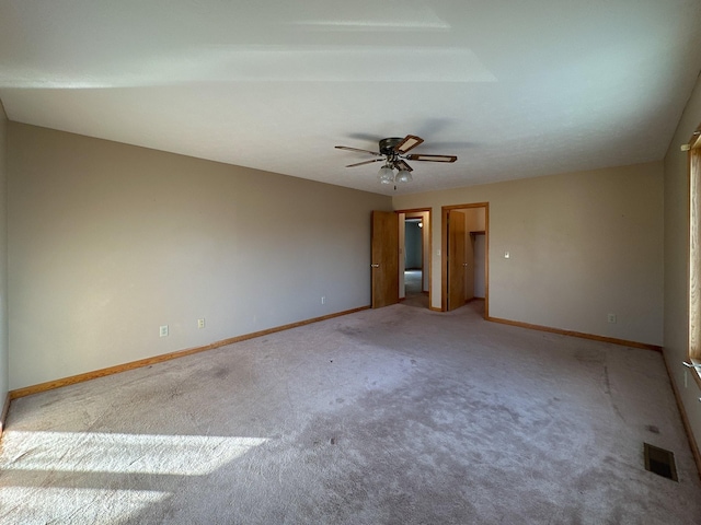 carpeted empty room featuring ceiling fan