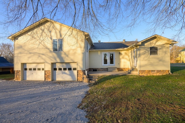 view of front of property with a front yard and a garage