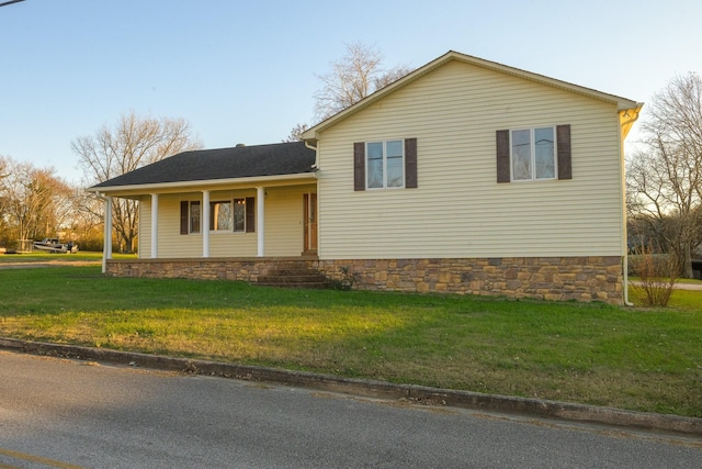 view of home's exterior with a lawn and covered porch