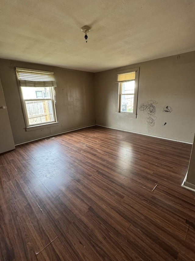 spare room with dark hardwood / wood-style floors