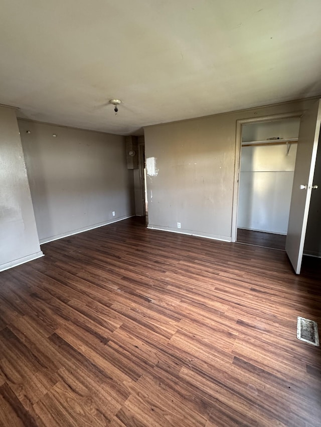 interior space with dark hardwood / wood-style floors and a closet