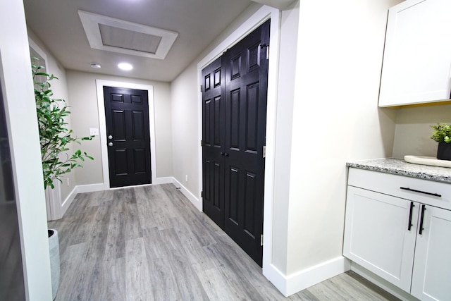 foyer entrance with light hardwood / wood-style floors