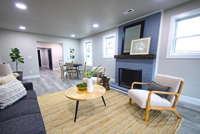 living room with a fireplace and light hardwood / wood-style floors