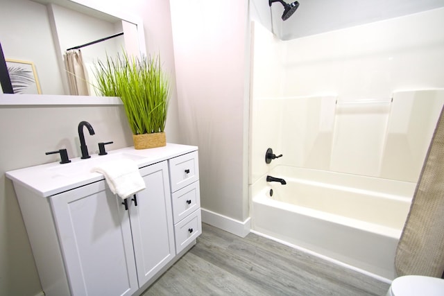 bathroom featuring wood-type flooring, vanity, and shower / bath combination with curtain