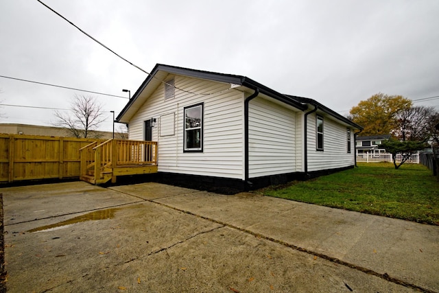 view of side of home with a yard