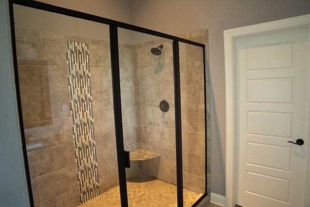 bathroom with a shower with door