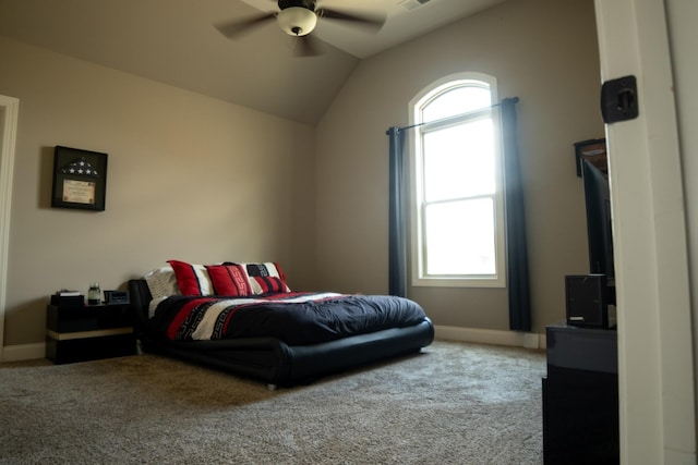 carpeted bedroom featuring ceiling fan, vaulted ceiling, and multiple windows