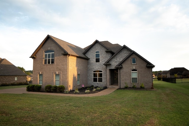 french country inspired facade featuring a front yard