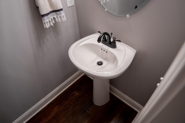 bathroom with hardwood / wood-style floors