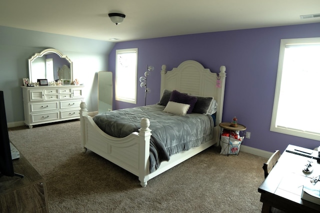 carpeted bedroom featuring lofted ceiling