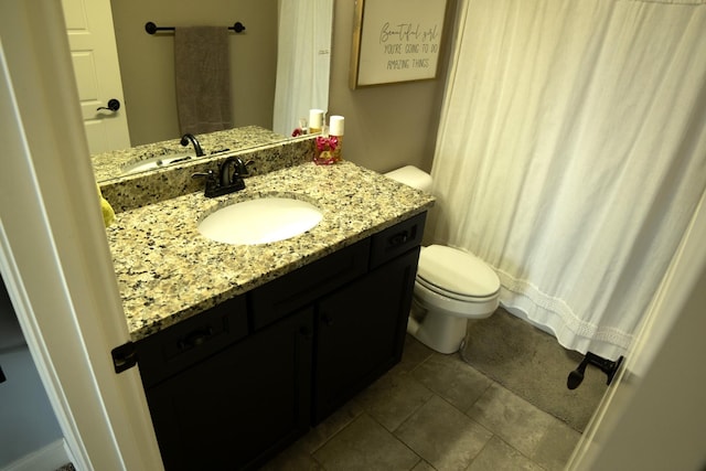 bathroom featuring tile patterned floors, vanity, and toilet