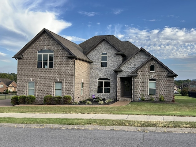 french country inspired facade with a front lawn