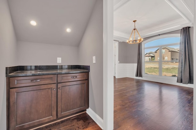 kitchen with wainscoting, dark wood-style flooring, pendant lighting, a notable chandelier, and recessed lighting