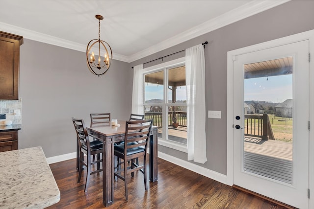 dining area featuring an inviting chandelier, baseboards, dark wood finished floors, and crown molding