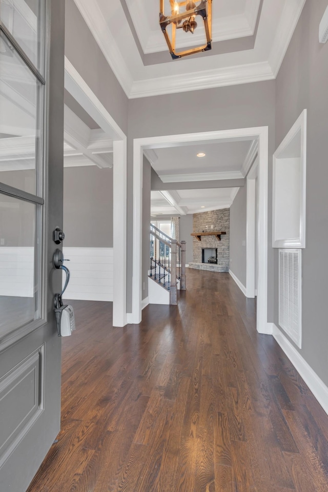 entryway featuring coffered ceiling, dark wood-style flooring, visible vents, and a fireplace