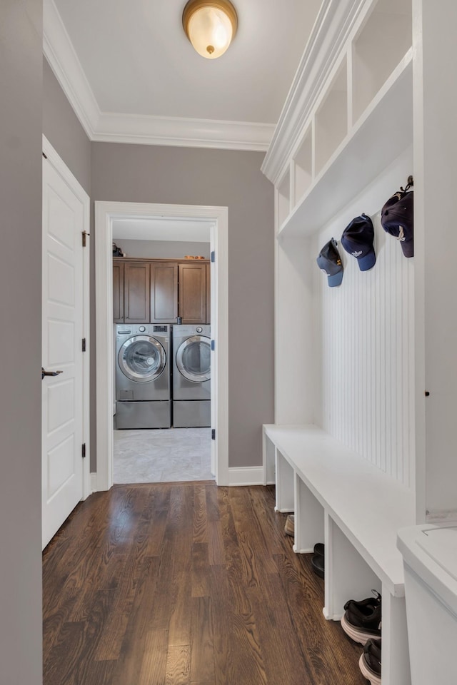 mudroom with dark wood-style floors, ornamental molding, independent washer and dryer, and baseboards