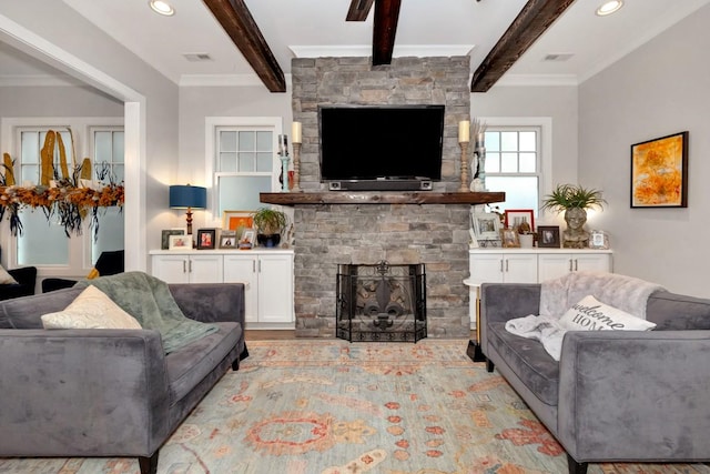 living room featuring beam ceiling, crown molding, a fireplace, and light hardwood / wood-style flooring