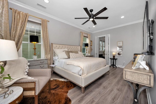 bedroom featuring ceiling fan, wood-type flooring, and ornamental molding