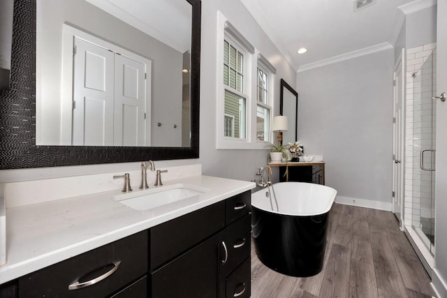 bathroom featuring hardwood / wood-style flooring, vanity, ornamental molding, and independent shower and bath