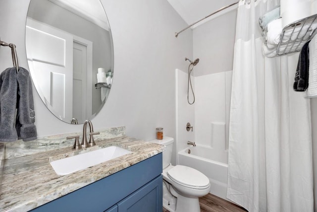 full bathroom featuring shower / bath combo with shower curtain, hardwood / wood-style floors, vanity, and toilet