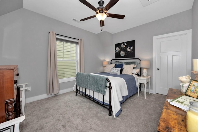 carpeted bedroom with vaulted ceiling and ceiling fan