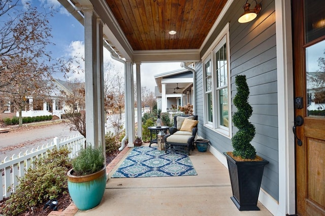 sunroom / solarium featuring plenty of natural light, wooden ceiling, and ceiling fan