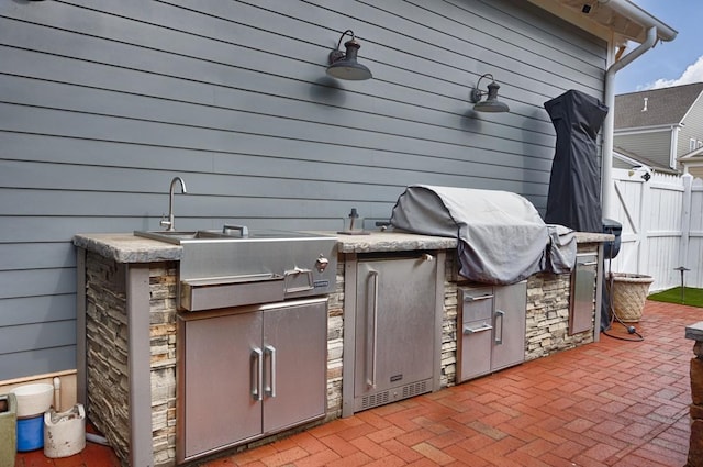 view of patio with a grill and exterior kitchen