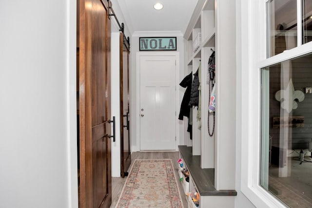 mudroom with hardwood / wood-style flooring and a barn door