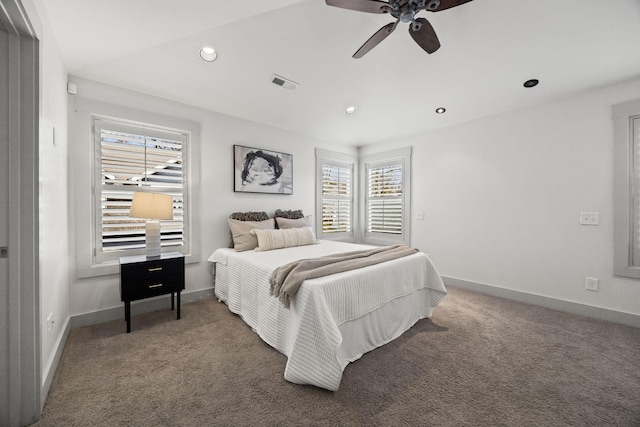 bedroom with ceiling fan and dark carpet