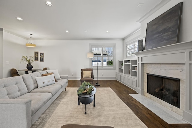 living room with a fireplace, dark hardwood / wood-style flooring, and crown molding