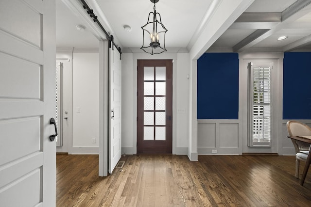 entrance foyer with a barn door, plenty of natural light, dark wood-type flooring, and coffered ceiling