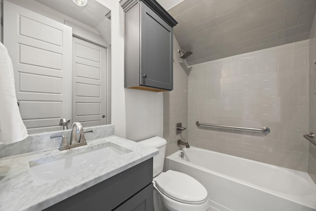 full bathroom featuring vanity, toilet, and tiled shower / bath