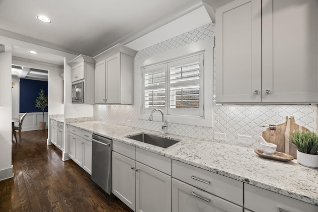 kitchen featuring light stone countertops, sink, dark wood-type flooring, white cabinets, and appliances with stainless steel finishes