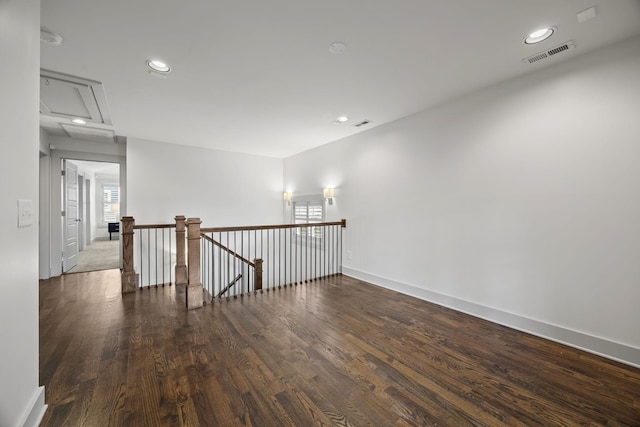 unfurnished room with dark hardwood / wood-style flooring and a wealth of natural light