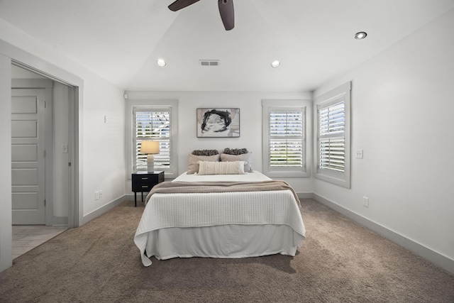 bedroom with ceiling fan, lofted ceiling, light carpet, and multiple windows