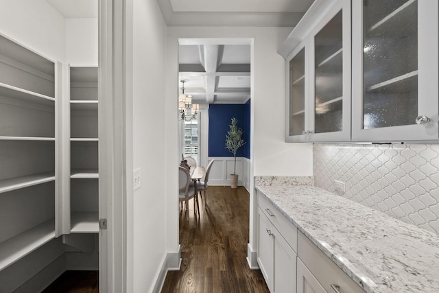 bar featuring decorative backsplash, dark hardwood / wood-style flooring, coffered ceiling, beamed ceiling, and white cabinetry