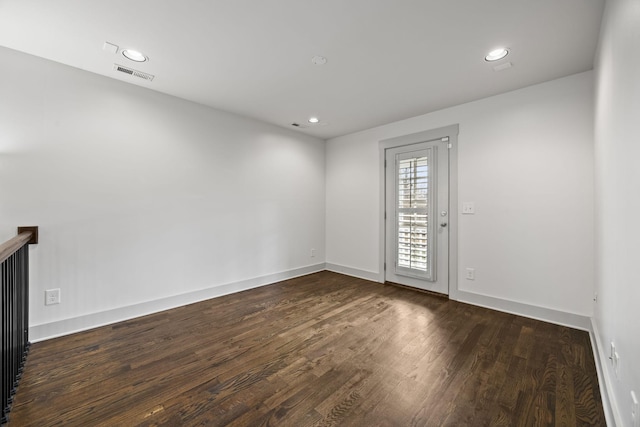 spare room with dark wood-type flooring