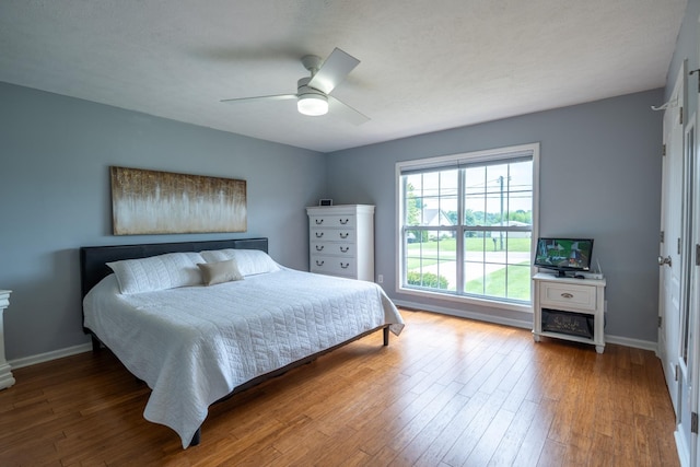 bedroom featuring ceiling fan and wood-type flooring