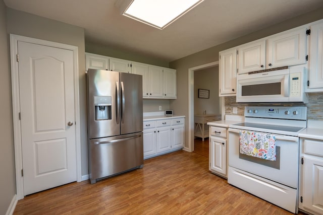 kitchen featuring tasteful backsplash, white cabinetry, light hardwood / wood-style flooring, and white appliances