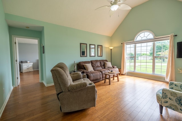 living room featuring hardwood / wood-style floors, high vaulted ceiling, and ceiling fan