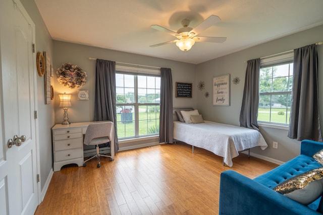 bedroom with light hardwood / wood-style floors and ceiling fan