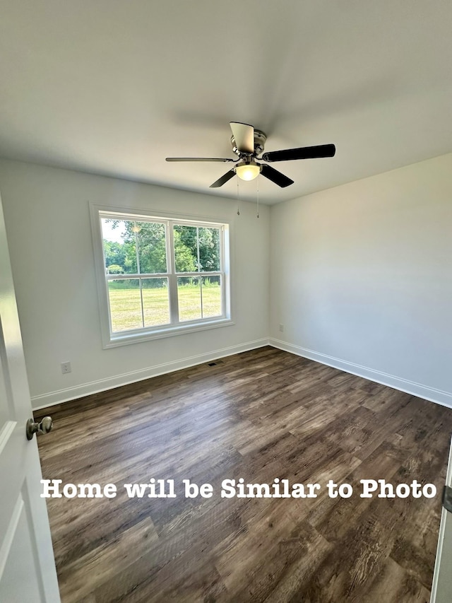 spare room featuring dark wood-type flooring and ceiling fan