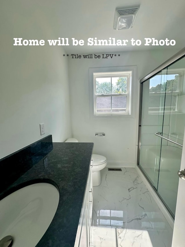 bathroom featuring vanity, toilet, and walk in shower