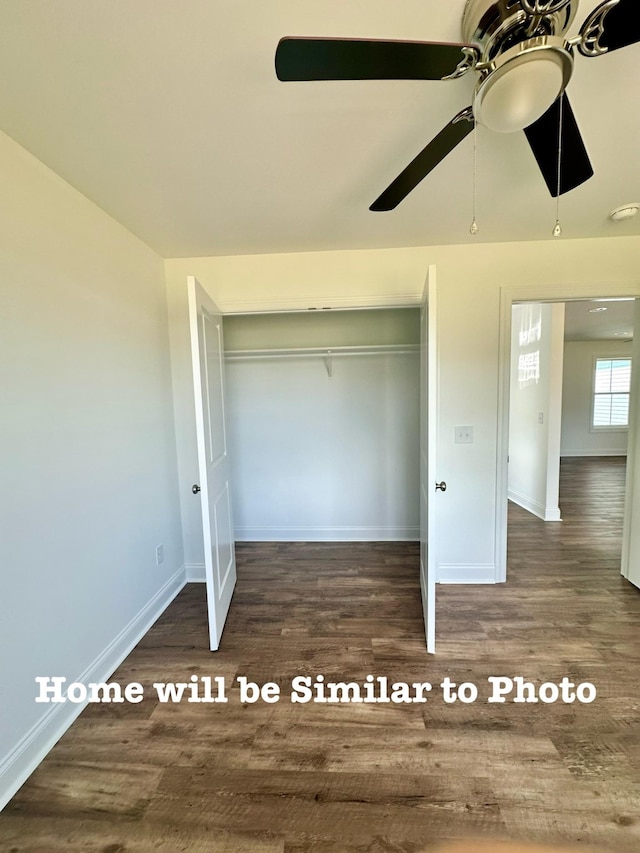 unfurnished bedroom featuring dark wood-type flooring, ceiling fan, and a closet