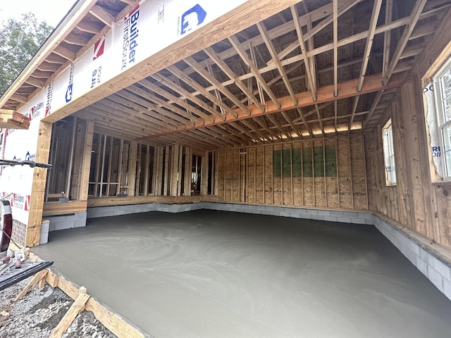 misc room with a healthy amount of sunlight and concrete floors