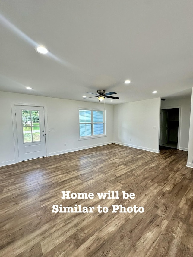 unfurnished room featuring ceiling fan and dark hardwood / wood-style floors