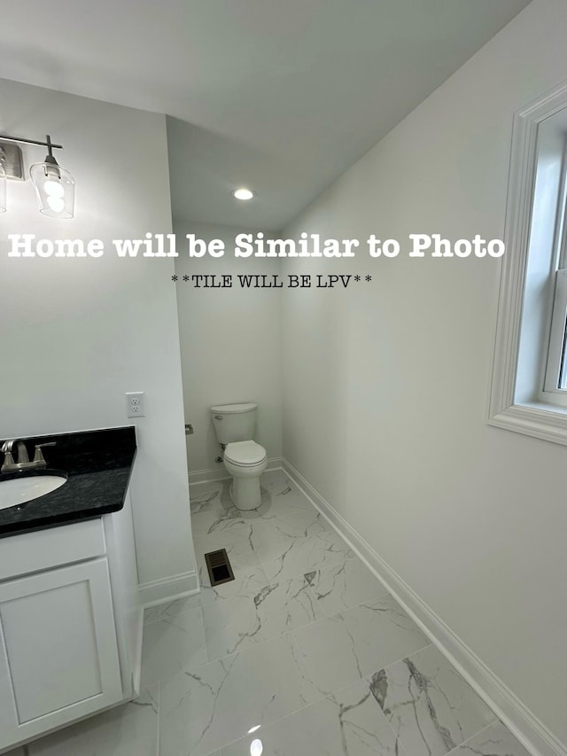 bathroom with vanity and toilet