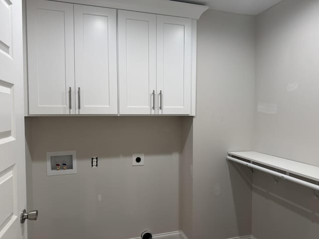 clothes washing area featuring electric dryer hookup, hookup for a washing machine, and cabinets