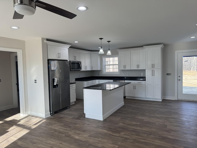 kitchen featuring white cabinetry, pendant lighting, a wealth of natural light, and stainless steel appliances