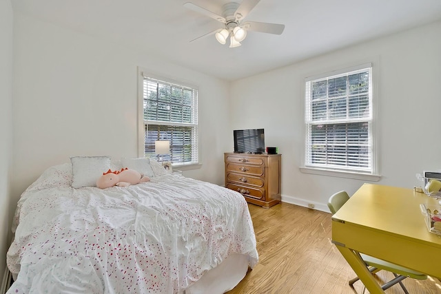 bedroom with light hardwood / wood-style flooring and ceiling fan